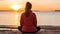 Serene woman practicing yoga on the seashore with breathtaking ocean view from behind