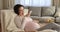 Serene young pregnant woman enjoy pleasant remote conversation on speakerphone