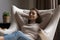 Serene young woman relax leaned on cozy armchair