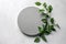 Serenity in Simplicity: Empty Round Podium and Green Leaves on Light Grey Background (AI Generated)