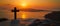 Serenity at Sunset: A Cross Silhouetted Against the Beauty of Santorini, Greece