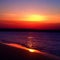 Serenity in Sunset: Tranquil Beach, Fiery Skies, and Gentle Waves