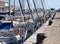 A series of boats moored in the port of Pesaro in front of the mooring bollards on the pier Marche, Italy