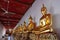 A series of gilded Buddha statues on display for pilgrims in one of the temples