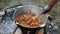 A series of the process of cooking pilaf in a cauldron on the street. handmade oriental cuisine. frying onions and vegetables,