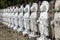 A series of small Buddha statues in a Japanese park