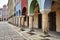 A series of stone columns in the arcades of historic tenement houses on the market square