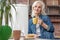 Serine old lady drinking tea at home