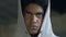 Serious African-American boy wearing hoody, preparing for crime, hooligan