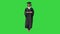 Serious African American female graduate walking with diploma on a Green Screen, Chroma Key.