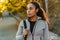 Serious african american sportswoman walking with bag