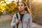 Serious african american sportswoman walking with bag in park