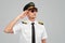 Serious airline captain saluting in studio