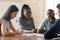 Serious anxious colleagues gathered together in boardroom solve work problems