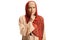 Serious arab woman in a hijab gesturing silence with finger over mouth