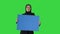 Serious Arab woman in hijab holding blank blue poster and looking at camera on a Green Screen, Chroma Key.