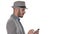 Serious arabic casual man using smartphone while walking on white background.