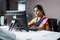 Serious bank employee busy working on computer in front of customer - concept of woman empowerment, job or career and