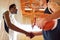 Serious basketball players from different team shaking hands