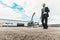 Serious bearded man carrying the suitcase on helicopter platform