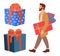 Serious bearded man is standing with presents in his hands. Young shopper guy near big gift boxes