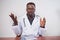 Serious Black doctor gestures with hands while discussing on telehealth call