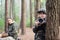 Serious boy with camera in forest