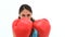 Serious brunette woman boxing with red gloves