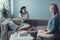 Serious brunette woman sitting on sofa in psychology cabinet