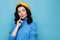 Serious brunette woman in yellow beret wear blue turtleneck sweater thinking, having tricky plan in mind, looking away at copy