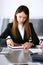 Serious business woman headshot. Asian businesswoman at meeting or negotiation in modern office