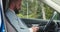 Serious businessman texting on smartphone in car, sitting on driver`s seat