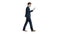 Serious businessman using phone voice dial while walking on whit