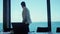 Serious businessman watching sea window back view. Leader person waiting alone