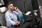 Serious Businessman working in office at computer Desk and talking on landline