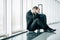 Serious businessman worrying something, sitting and touch his head at the airport terminal. Businessman miss his flight. Young man