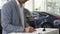 The serious buyer signs the documents on the purchase of the car