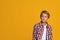 Serious calm blond teenage boy student in shirt looking at empty space