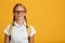 Serious calm smart caucasian teenager girl student in glasses with pigtails look at camera