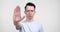 Serious Caucasian Man Showing Stop Gesture on White Background