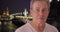 Serious Caucasian man stares sternly near Pont Alexandre III in Paris