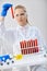 Serious chemical technician holds test tubes with red liquid