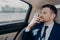 Serious company executive thinking of making serious decision while sitting in car