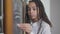 Serious concentrated left-handed schoolgirl writing with chalk on blackboard in classroom. Portrait of beautiful