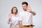 Serious confident mature man and woman making stop gesture with outstretched arms