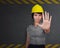 Serious construction woman making stop hand sign