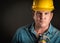 Serious Contractor in Hard Hat Holds Hammer With Dramatic Lighting