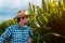 Serious corn farmer portrait in cultivated field