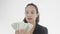 Serious dark-haired busensswoman with ponytail looks with satisfaction at pack of dollars in her hands counting. 4K 360