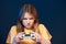 Serious determined girl playing video game with joystick